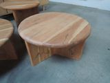 three wooden tables and two stools in a room
