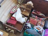a trunk full of suitcases and other items on the floor