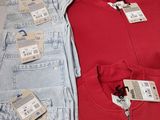 two pairs of men ' s clothing with price tags on them on a table