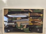 four knives in a box on a table