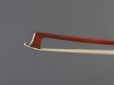 a close up of a violin ' s bow on a gray background