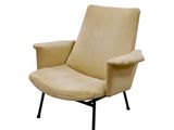 beige leather lounge chair with black metal legs and arms