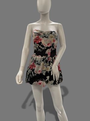 female mannequin wearing a black and pink dress with flowers on it