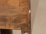 a close up of a wooden table with a drawer on it