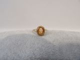 a gold ring with an oval stone in the center