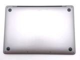 a close up of a silver laptop computer on a white surface