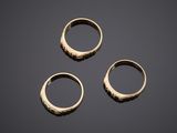 three gold rings on a black background