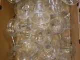 a box full of empty wine glasses sitting on the floor