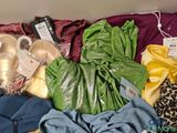 a pile of clothes and other items on a bed
