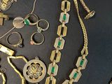 a lot of gold and silver jewelry on a black table