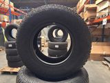 tires are stacked on pallets in a warehouse with pallets in the background