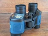 a pair of binoculars sitting on a wooden table