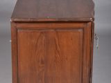 an old wooden cabinet with a drawer on top of it