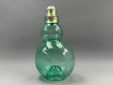 an image of a green glass bottle with a gold top