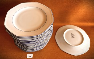 a stack of plates sitting on a table next to a bowl