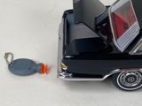 a toy car with a laptop on top of it and a keychain