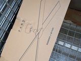 a cardboard box with a drawing of a tie on it