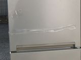 a stainless steel refrigerator with a glass door in a room