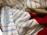 a close up of a pile of clothes with a label on it