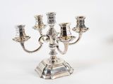 a silver candelab with five candles on it