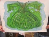 a person holding a painting of a green plant