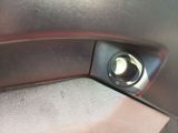 a close up of a car door handle with a button