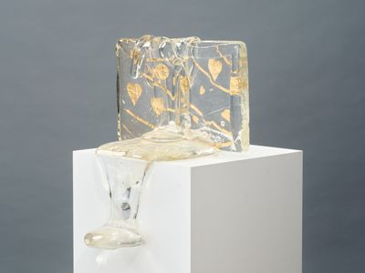 a glass vase sitting on top of a white pedestal