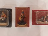 three miniature figurines of a woman on a motorcycle