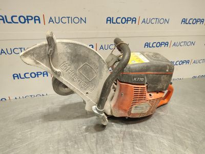 a close up of a chainsaw on a table in front of a wall