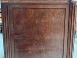 a wooden cabinet that is sitting in the middle of a room