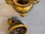 pair of antique brass vases with handles and handles on a white cloth