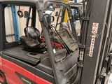 a forklift truck that is parked in a warehouse