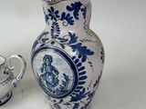 a blue and white vase and a teapot on a table