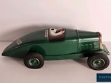 a green toy car that is sitting on a table