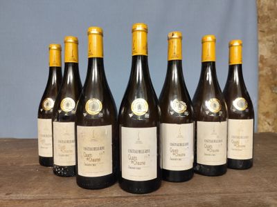 six bottles of wine are lined up on a wooden table