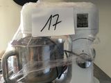 a mixer on a table with a sign on it