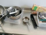 a lot of cooking utensils on the kitchen counter