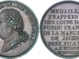 an old silver coin with a woman ' s profile on it