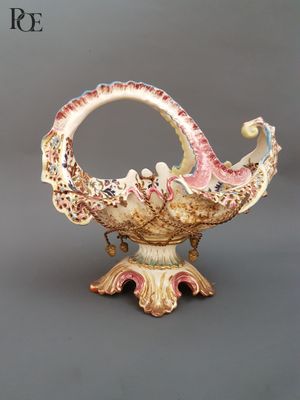 a vase that has a bird on it on a stand