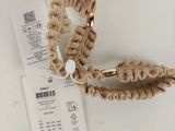 a crochet hair tie with a tag attached to it