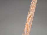 close up of a person ' s hand holding a piece of rusted metal