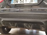 a close up of a car ' s exhaust pipe with a number plate on it