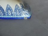 a blue and white vase sitting on a table