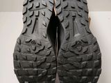 the soles of a pair of black hiking shoes on a white surface