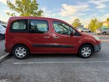 a red van parked in a parking lot next to a parking meter