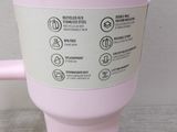 a pink coffee cup with a pink handle on a table