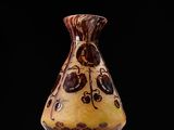 a brown and black vase sitting on a table