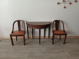 two chairs and a table in the corner of a room