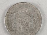 a close up of a coin on a table with a white background