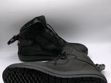 a pair of black shoes with black soles on a white background